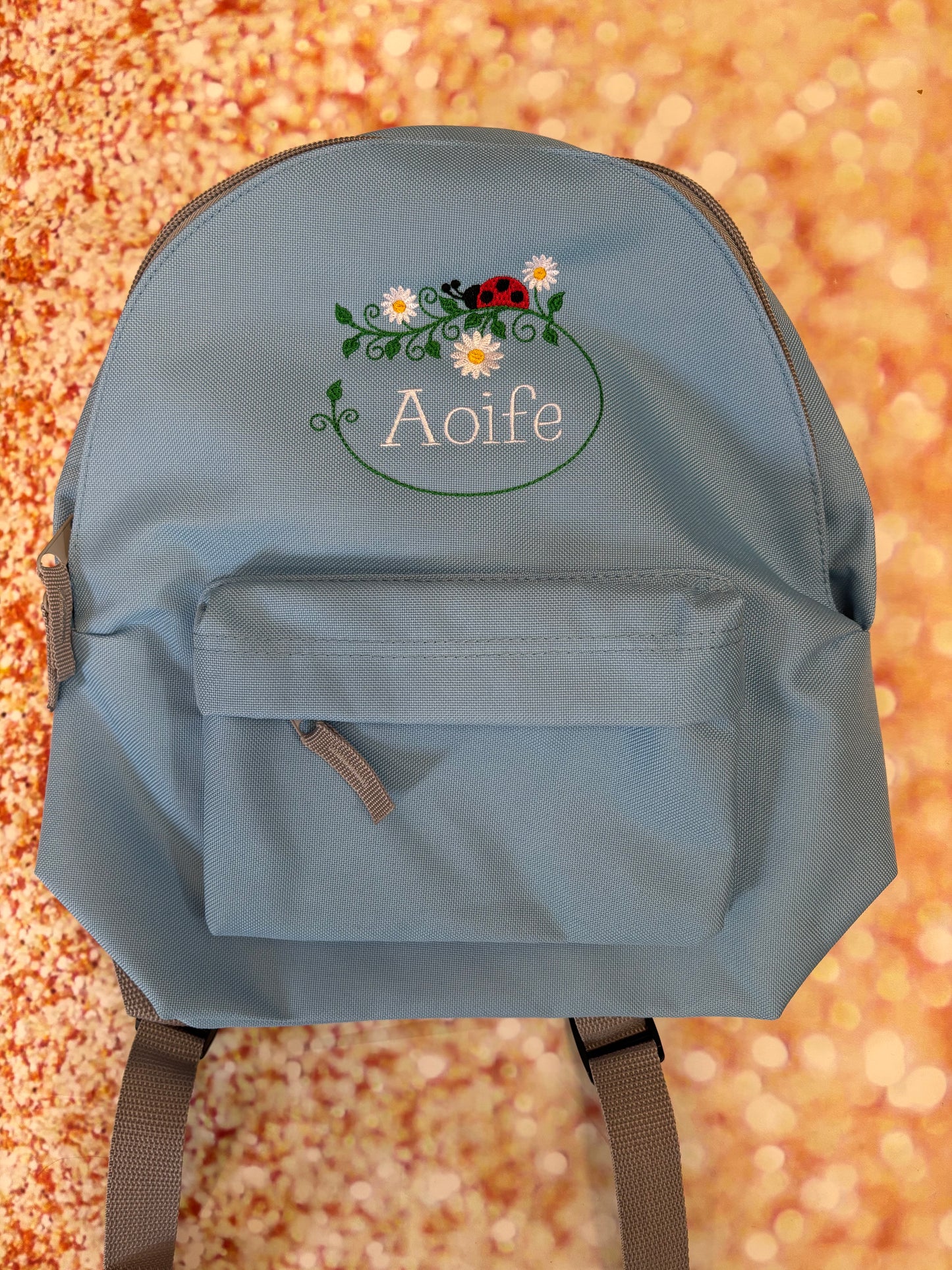 Personalised Nursery / Pre-School mini embroidered rucksack. Choice of colour bag. Childs small rucksack, Ladybird & Flowers Design