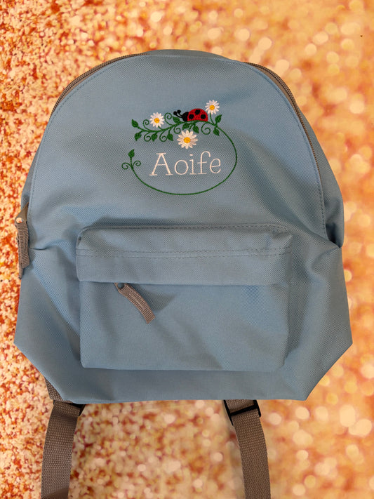 Personalised Nursery / Pre-School mini embroidered rucksack. Choice of colour bag. Childs small rucksack, Ladybird & Flowers Design